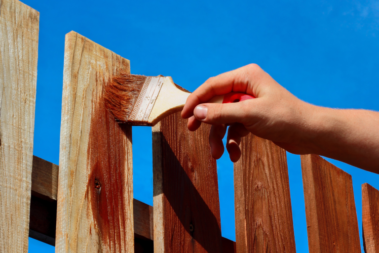CF- Wooden Fences wooden fence being stained